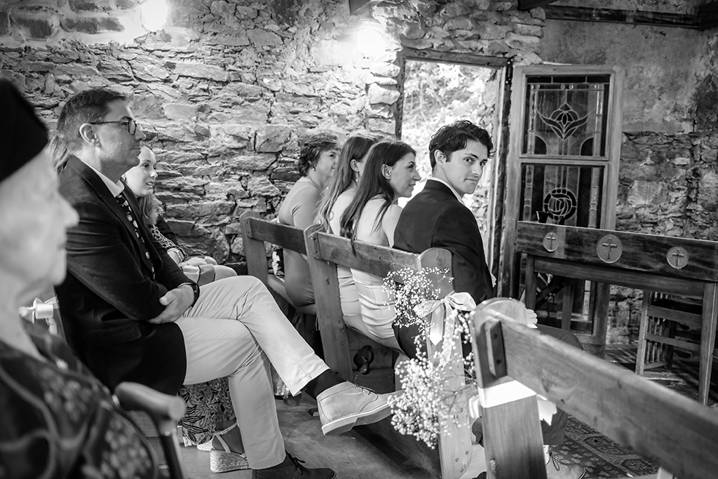 A candid shot of the bride's brother in black and white